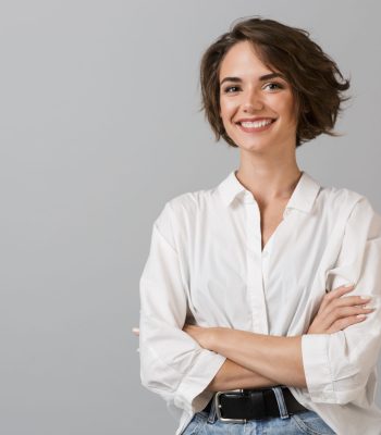 Image of happy young business woman posing isolated over grey wall background.